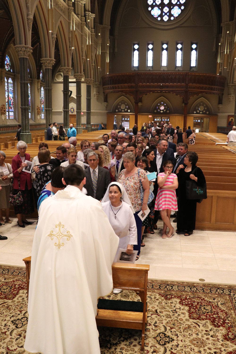 Following the Mass, Father Dufour confers individual blessings upon those gathered.